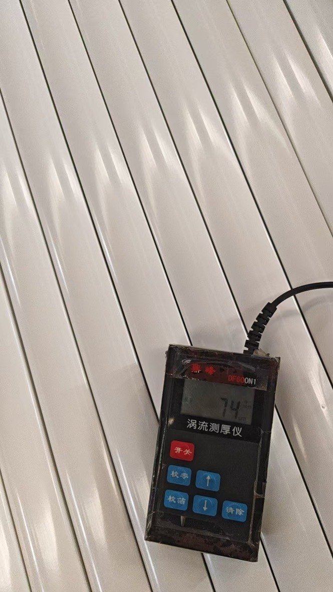Eddy current coating thickness gauge reading 74 on powder coated aluminum profiles